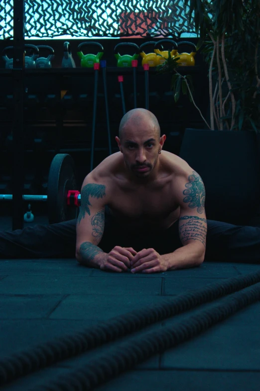 a man sitting on the ground doing exercises for his chest