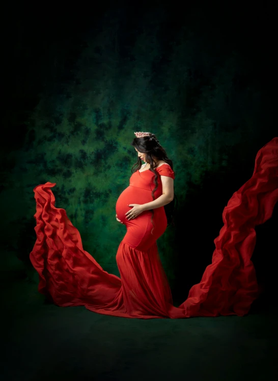 a pregnant woman in red is wearing an orange dress