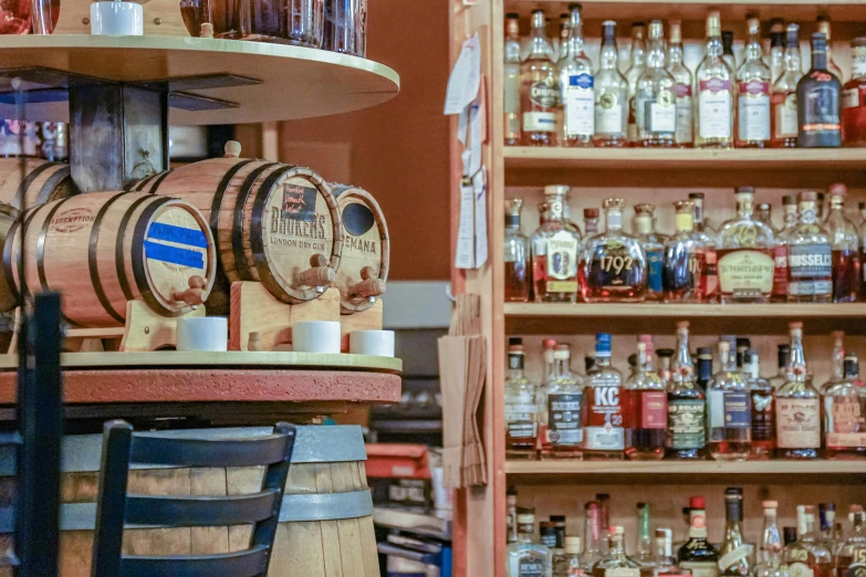 a variety of alcohol are being displayed behind bars