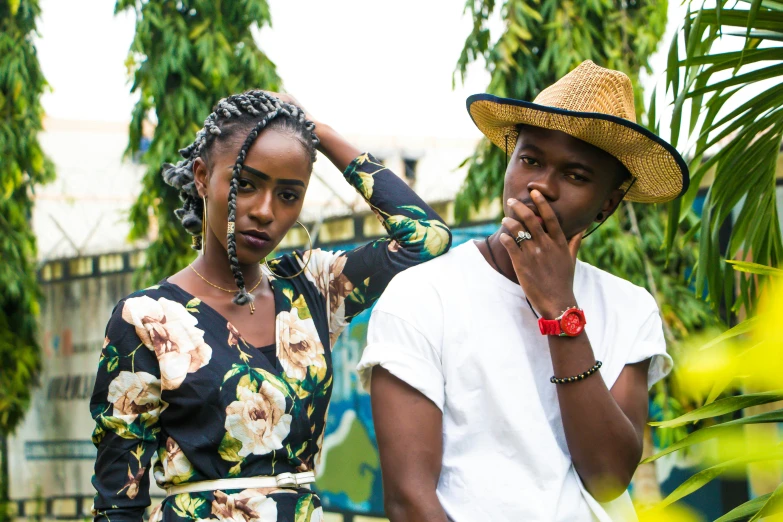 a man with a straw hat standing next to a woman