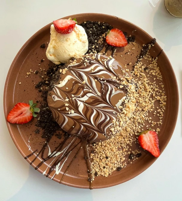 chocolate, vanilla and strawberries are sitting on a plate