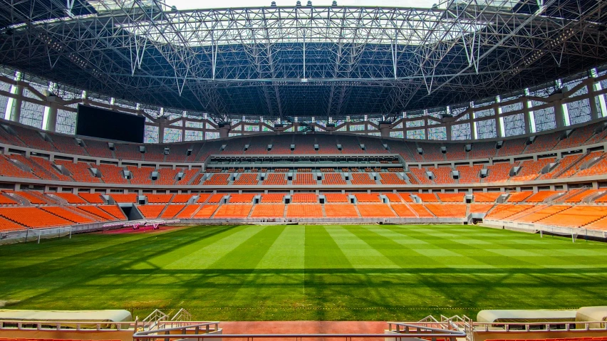 a large stadium with a green grass field