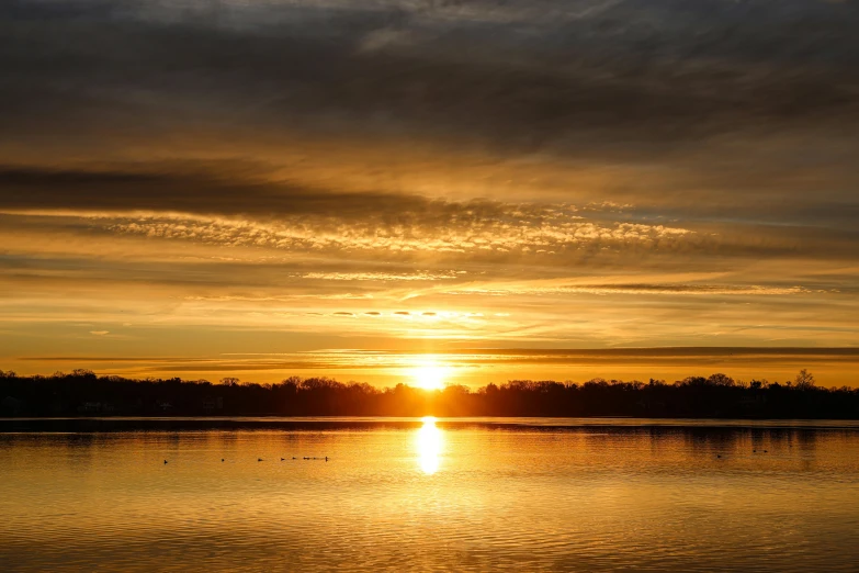 a large body of water with a sunset over it