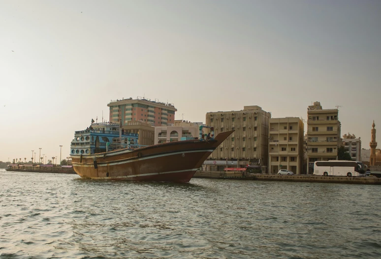 a boat traveling down a body of water near tall buildings