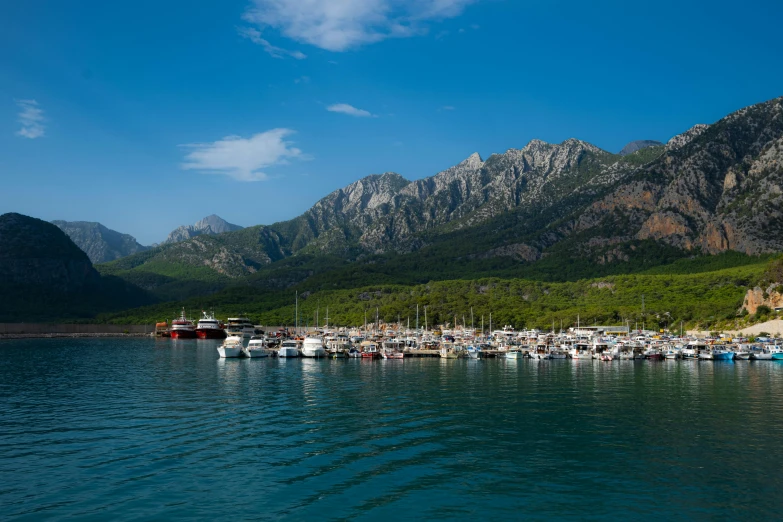 there is a harbor surrounded by mountains and boats