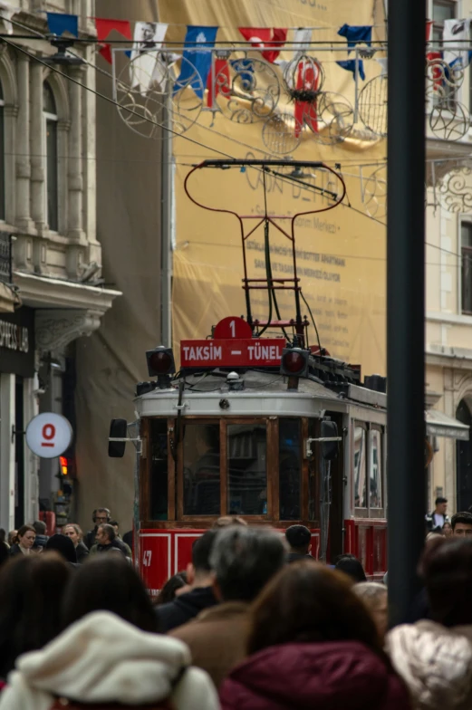 an electric trolley is traveling down the street