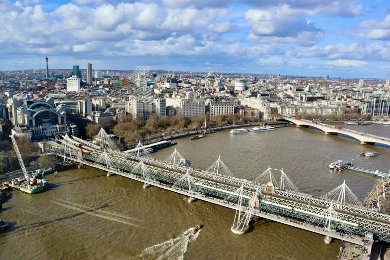 a bridge over a large river surrounded by tall buildings