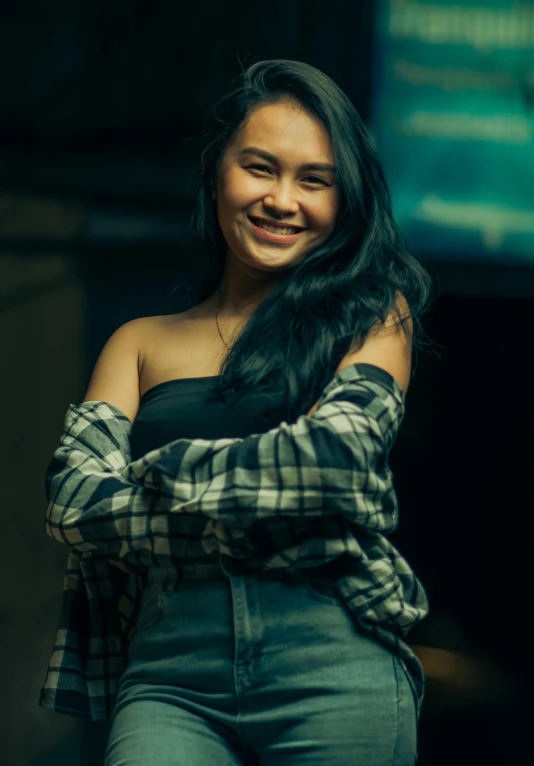 an indian woman smiling with her arms crossed