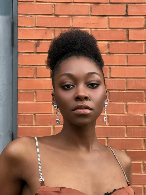 woman with short hair and diamond earrings looking at the camera