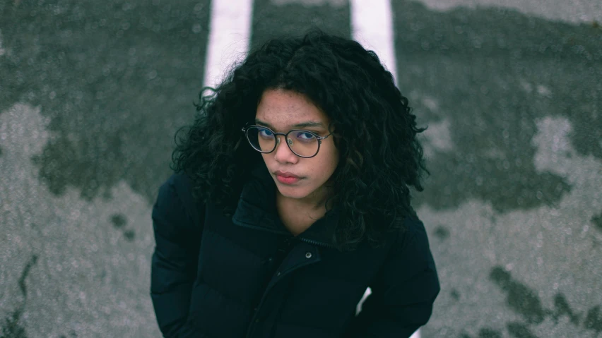 a person wearing eyeglasses while standing outside