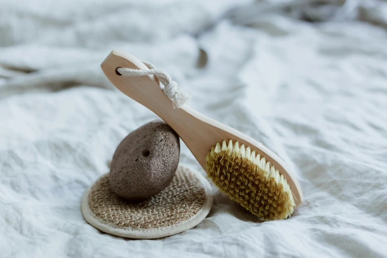 two bath sponges next to each other on white linen