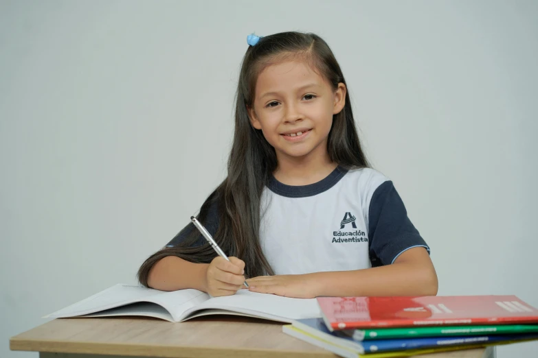 a  sitting at a desk with a book