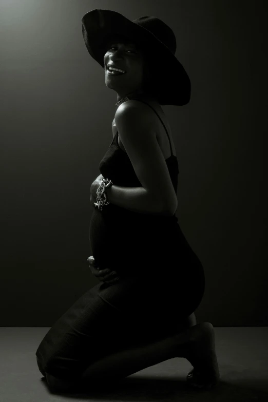 a woman sitting on the ground in a dark room