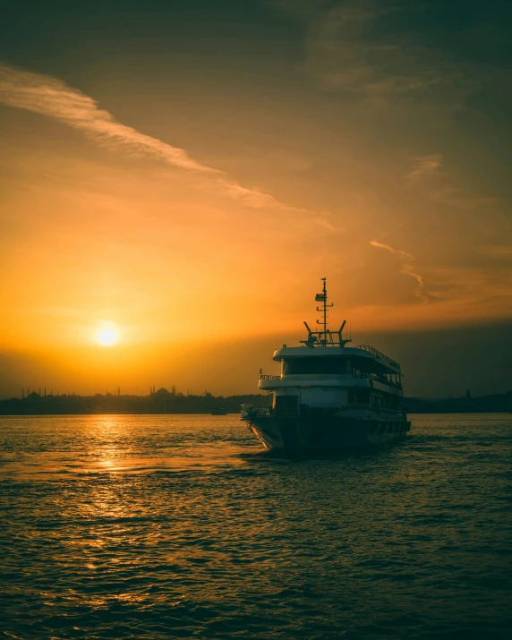 a large boat out on the water during a sunset