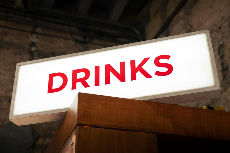 a drink is displayed on top of a shelf