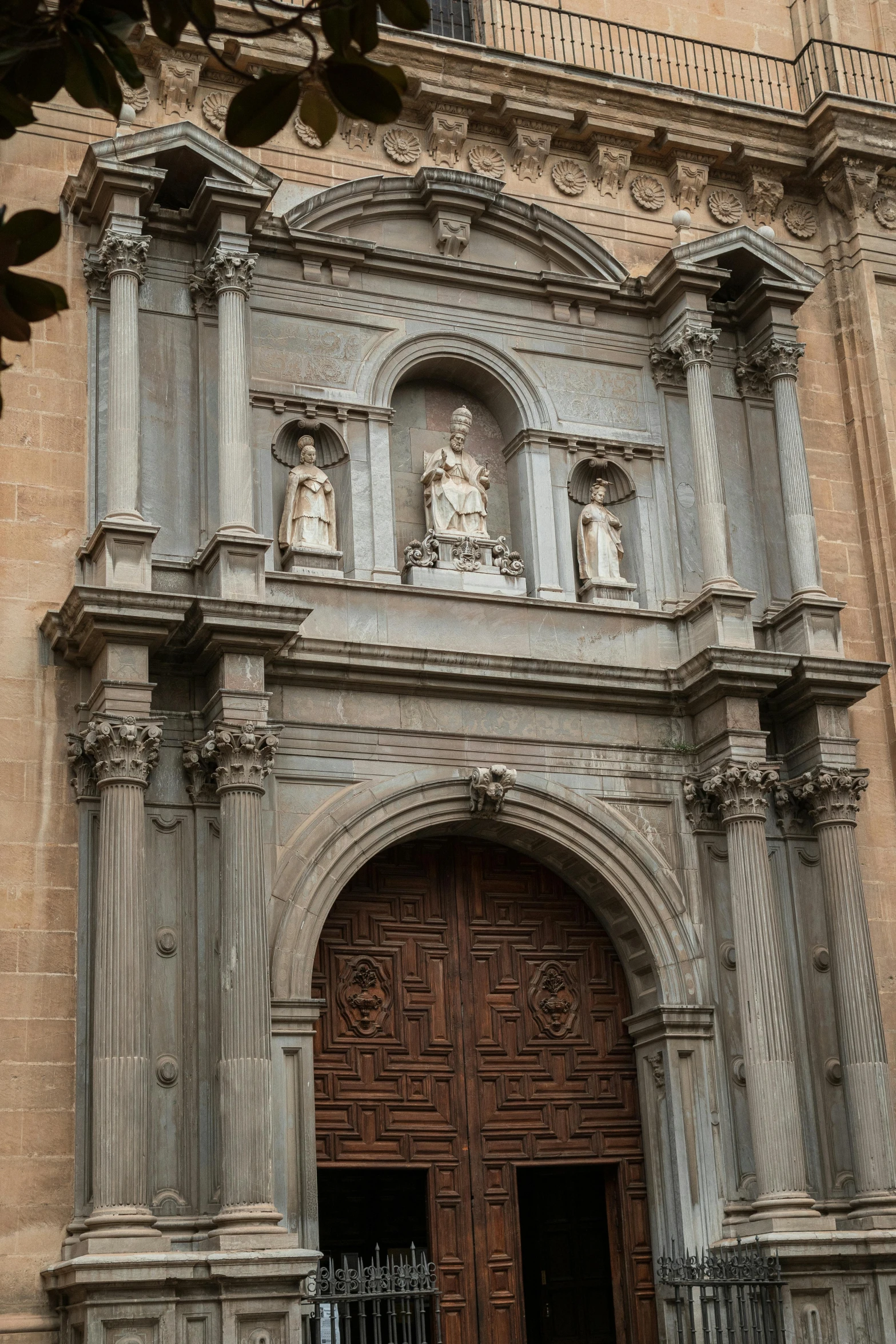 the front of a very tall building with a big door