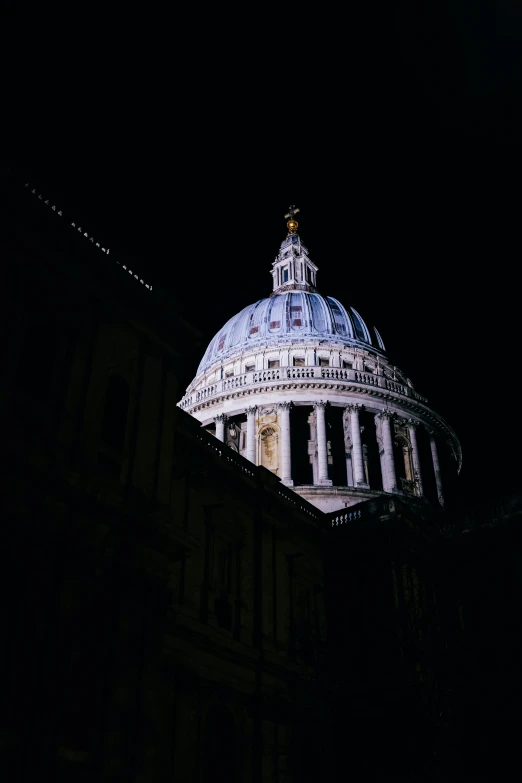 the dome of the city building illuminated up at night