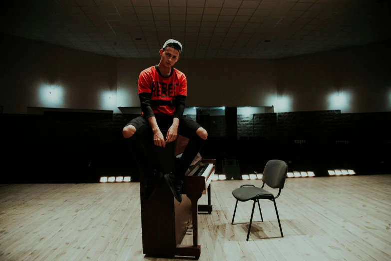 man on chair and standing over desk on floor