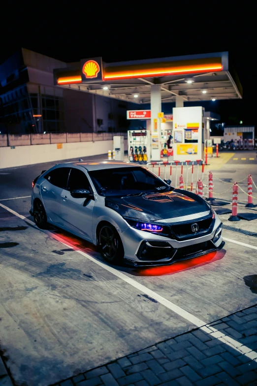 an electric car in a gas station at night