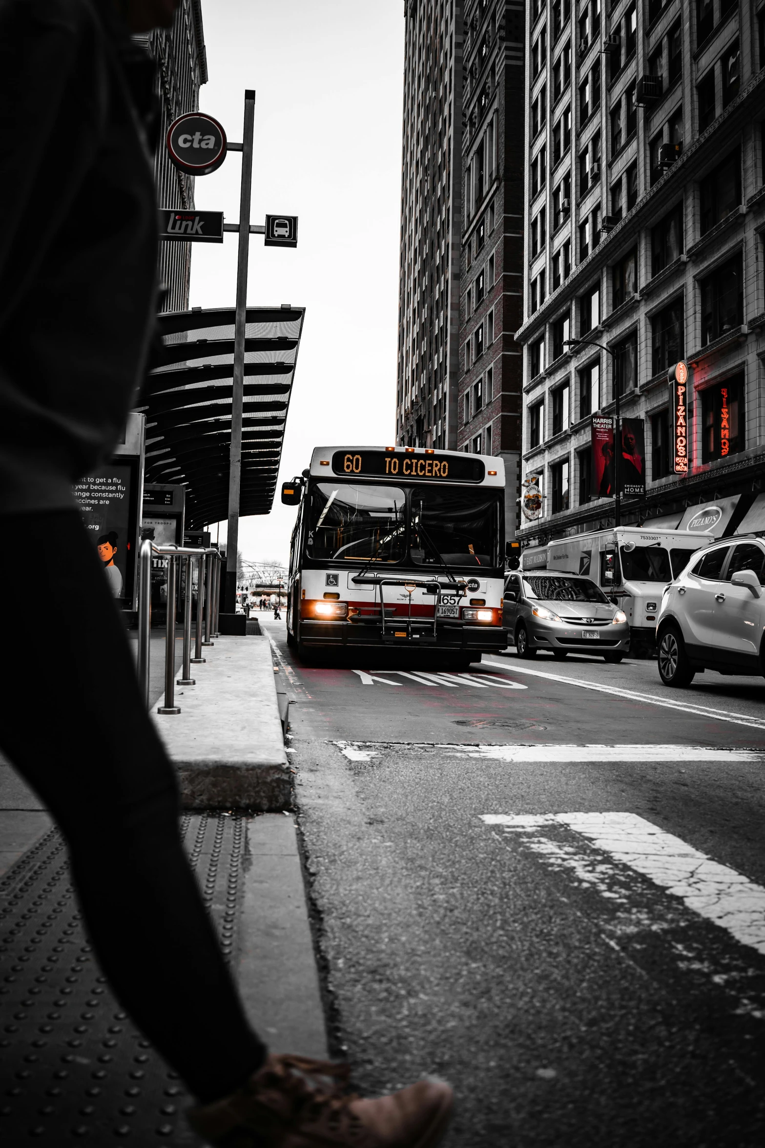 a bus is stopping at a stoplight in front of some buildings