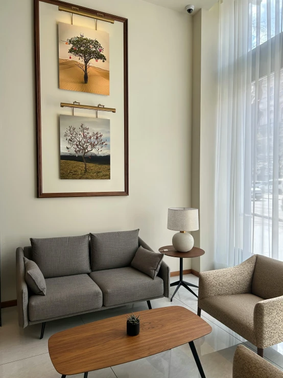 a living room with gray and tan chairs