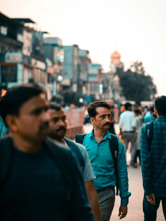 several people walking down the street in the city