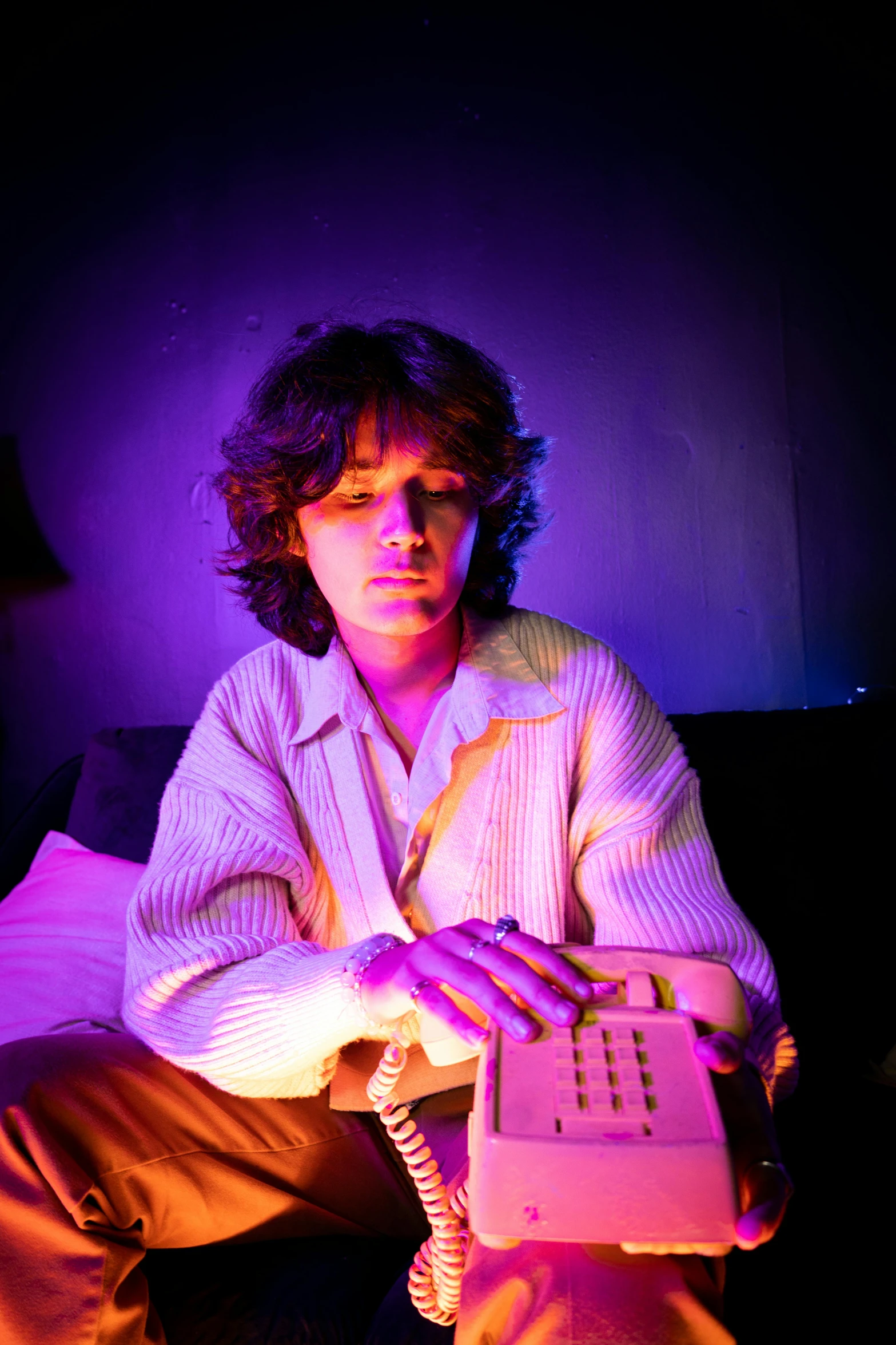 woman with short hair in shirt using old cellular phone