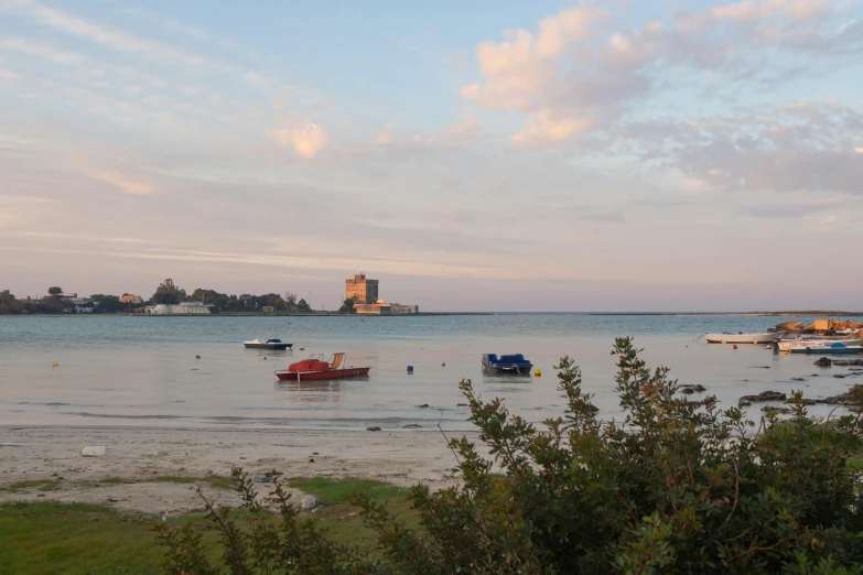 the harbor at sunset has several boats docked