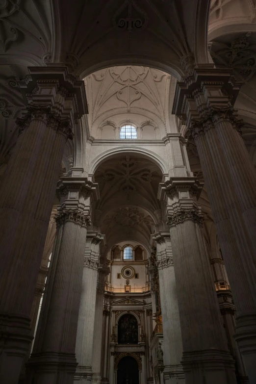 an interior of a large church with stone and wood columns