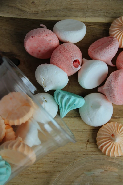 some small cakes sit on a wooden table