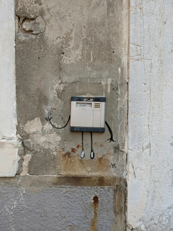 a piece of equipment on the wall, attached to the electrical outlet