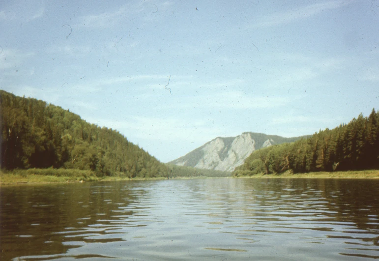 a mountain is seen across the water from a large lake