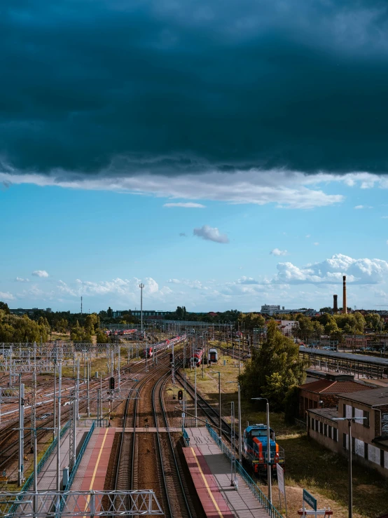 a train station that has trains on the tracks