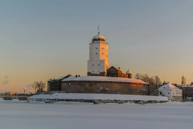 a clock tower standing in the middle of the winter