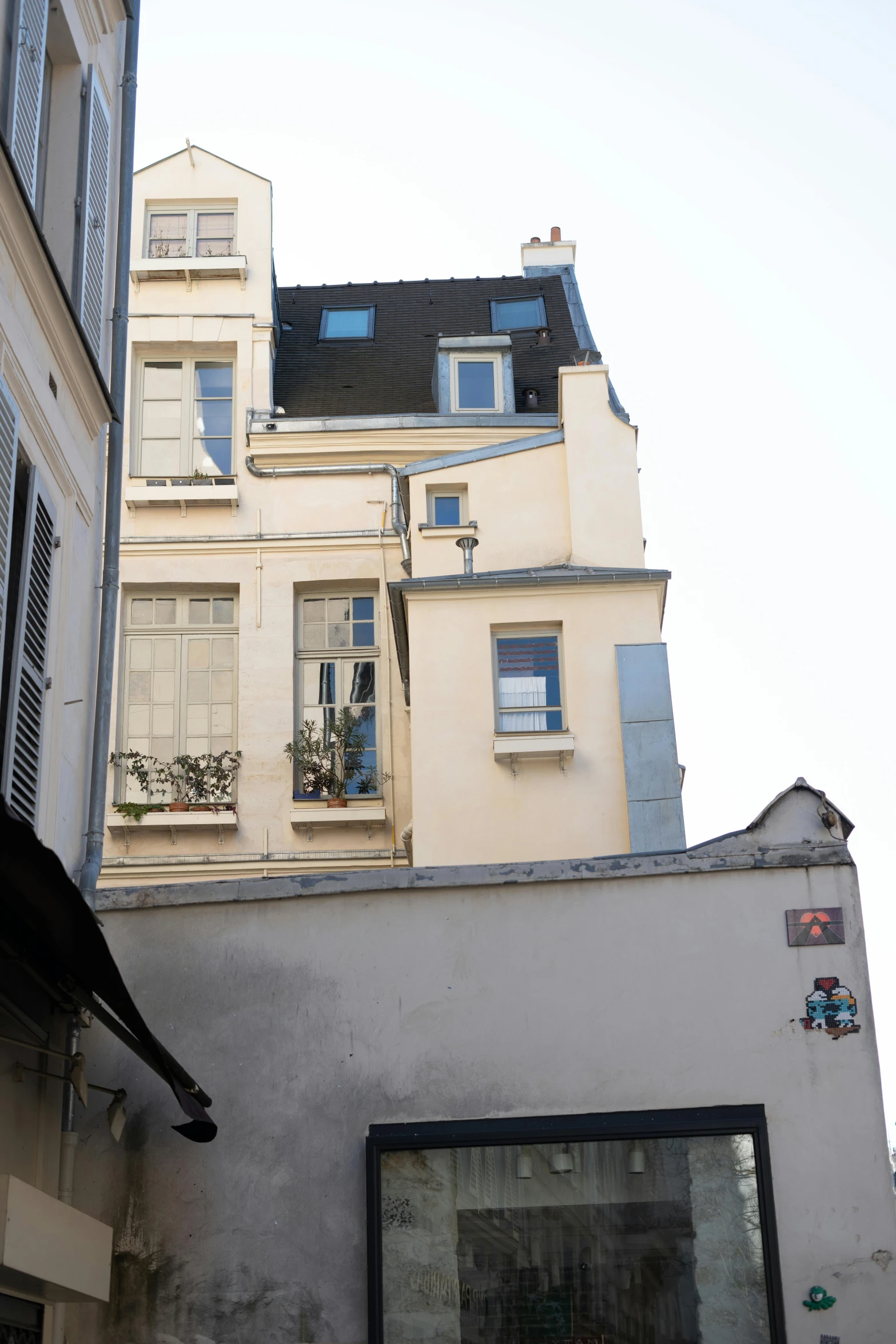 a view of the outside of two buildings from a side street