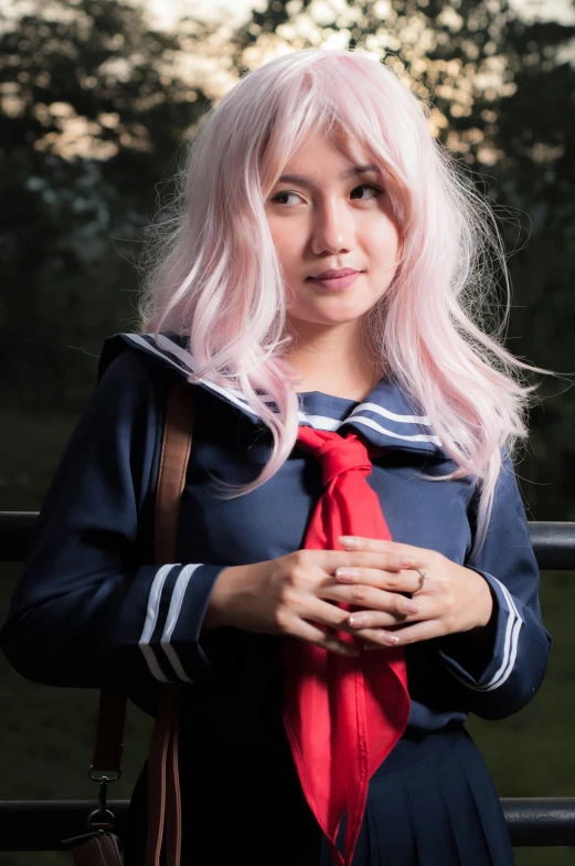 a woman with pink hair wearing a sailor uniform