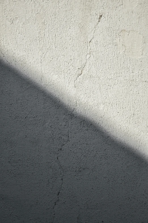 a white wall with the sunlight coming in on it