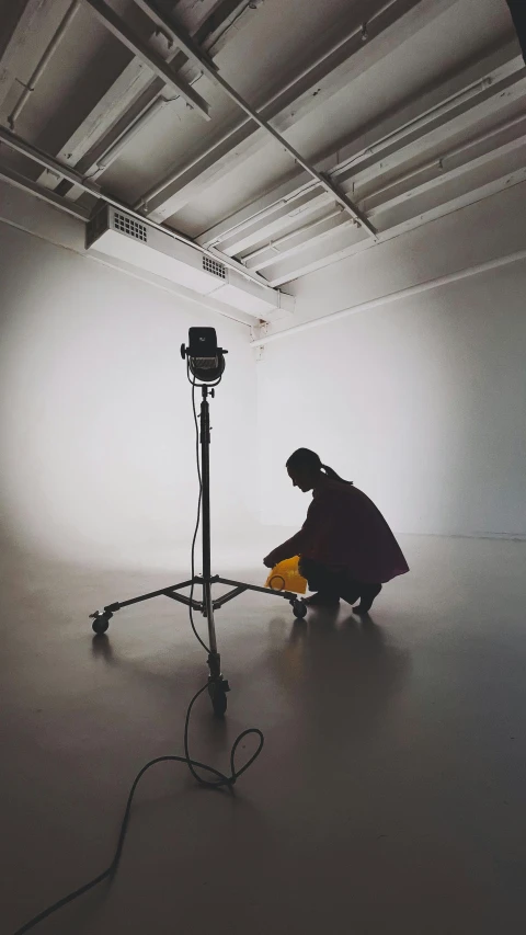 a man kneeling in front of a flash light