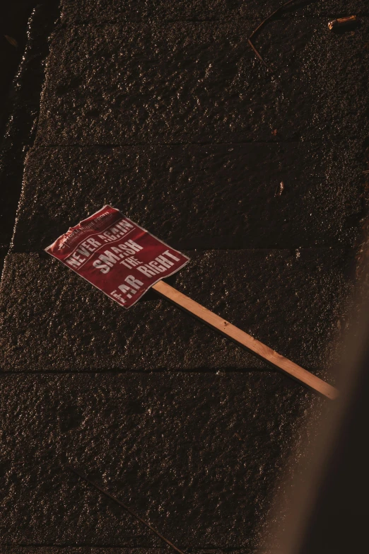 a warning sign sitting on the side of a street