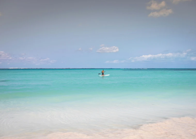 someone riding a surfboard in the middle of the ocean