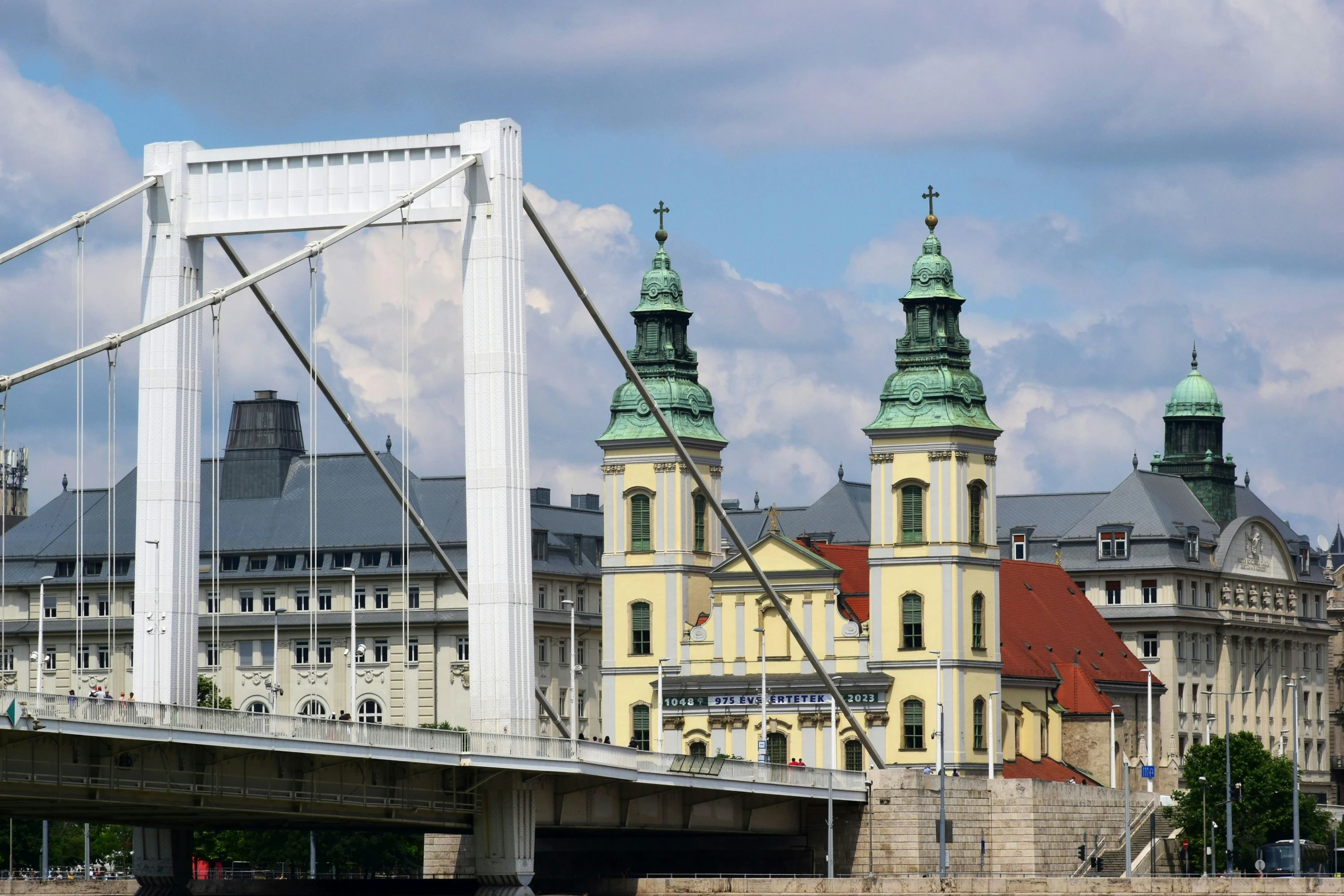 a bridge that has buildings on it, and towers in the background