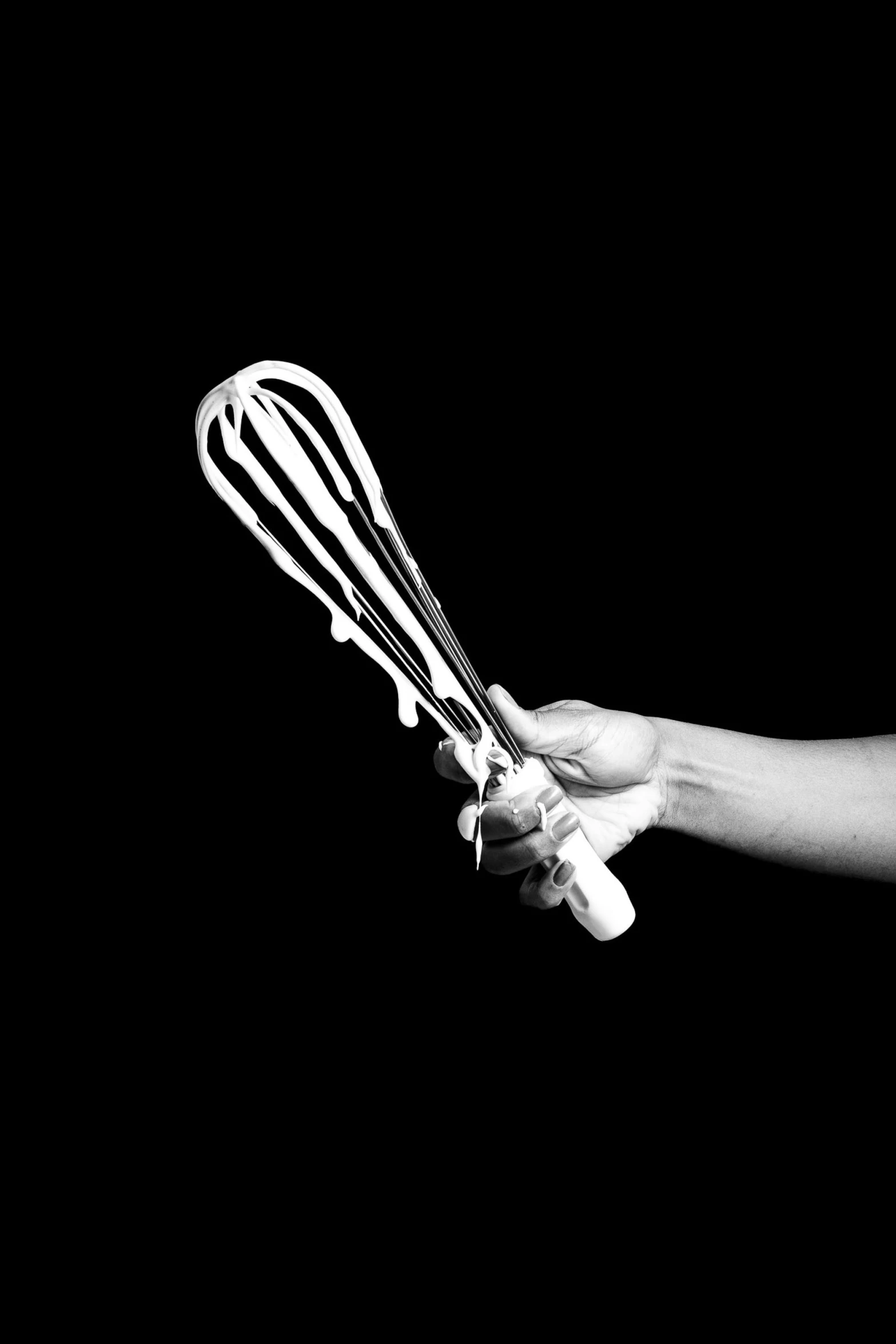 a hand with four whisks in each of them