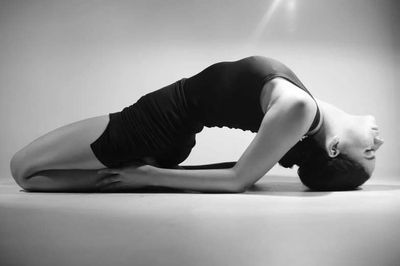 a black and white po of a woman doing yoga