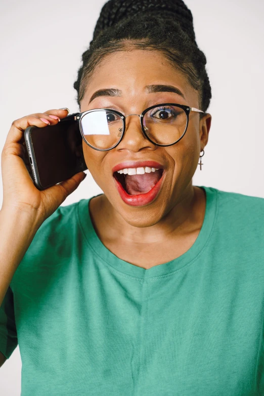 a person with glasses on holding a cell phone