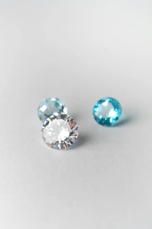 an oval brilliant set of gems sits atop a plain surface