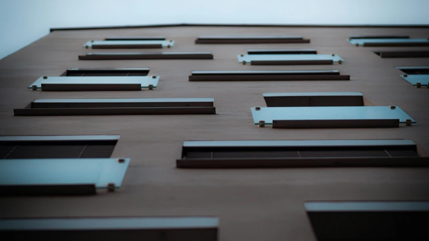 windows and shutters on a large brown building