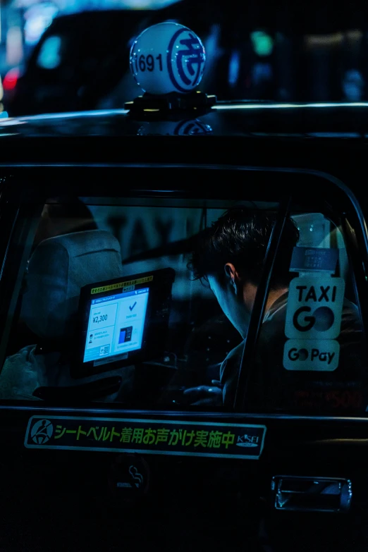 a man leaning out the window of a taxi cab