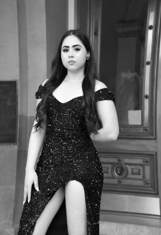 black and white pograph of a woman posing in a sequin dress