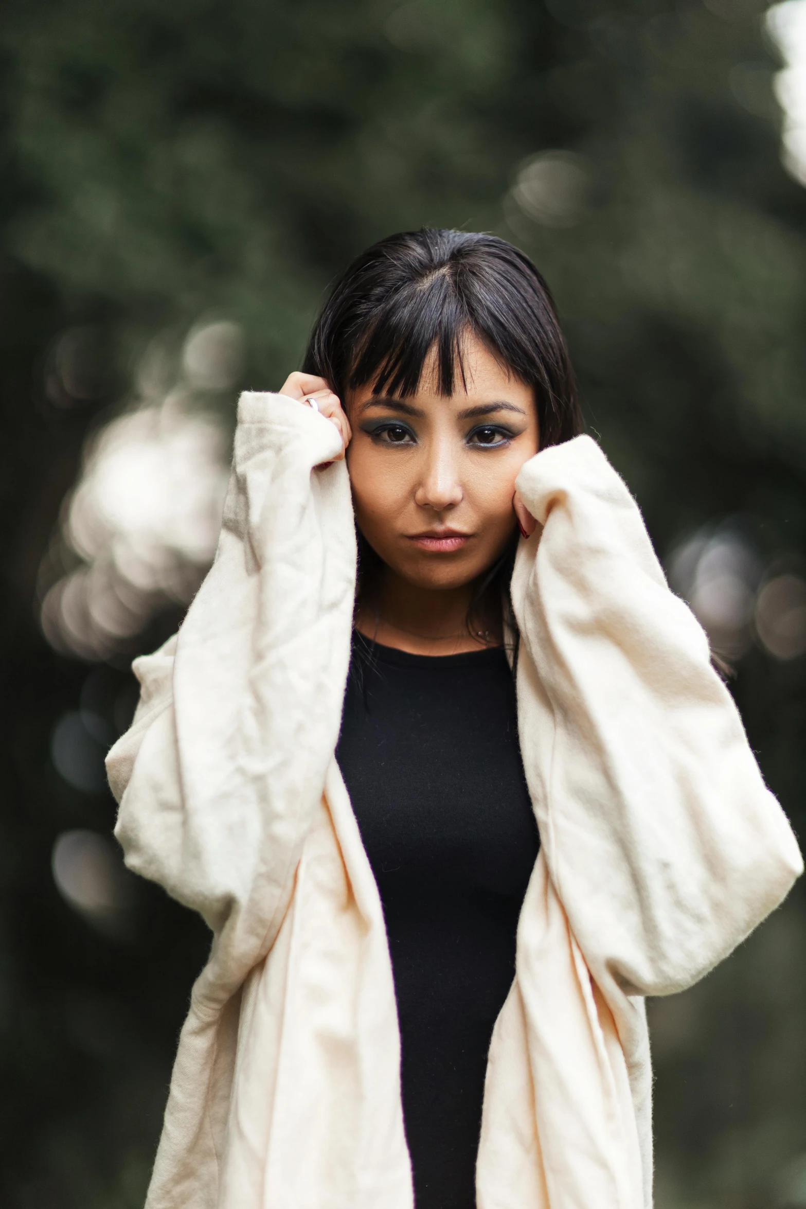 a woman poses for the camera with her fur coat on