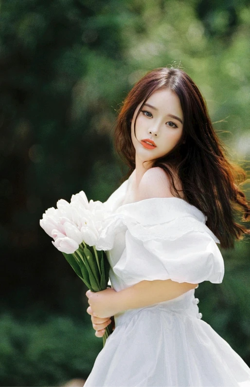 an asian woman holding a bunch of flowers in her hands